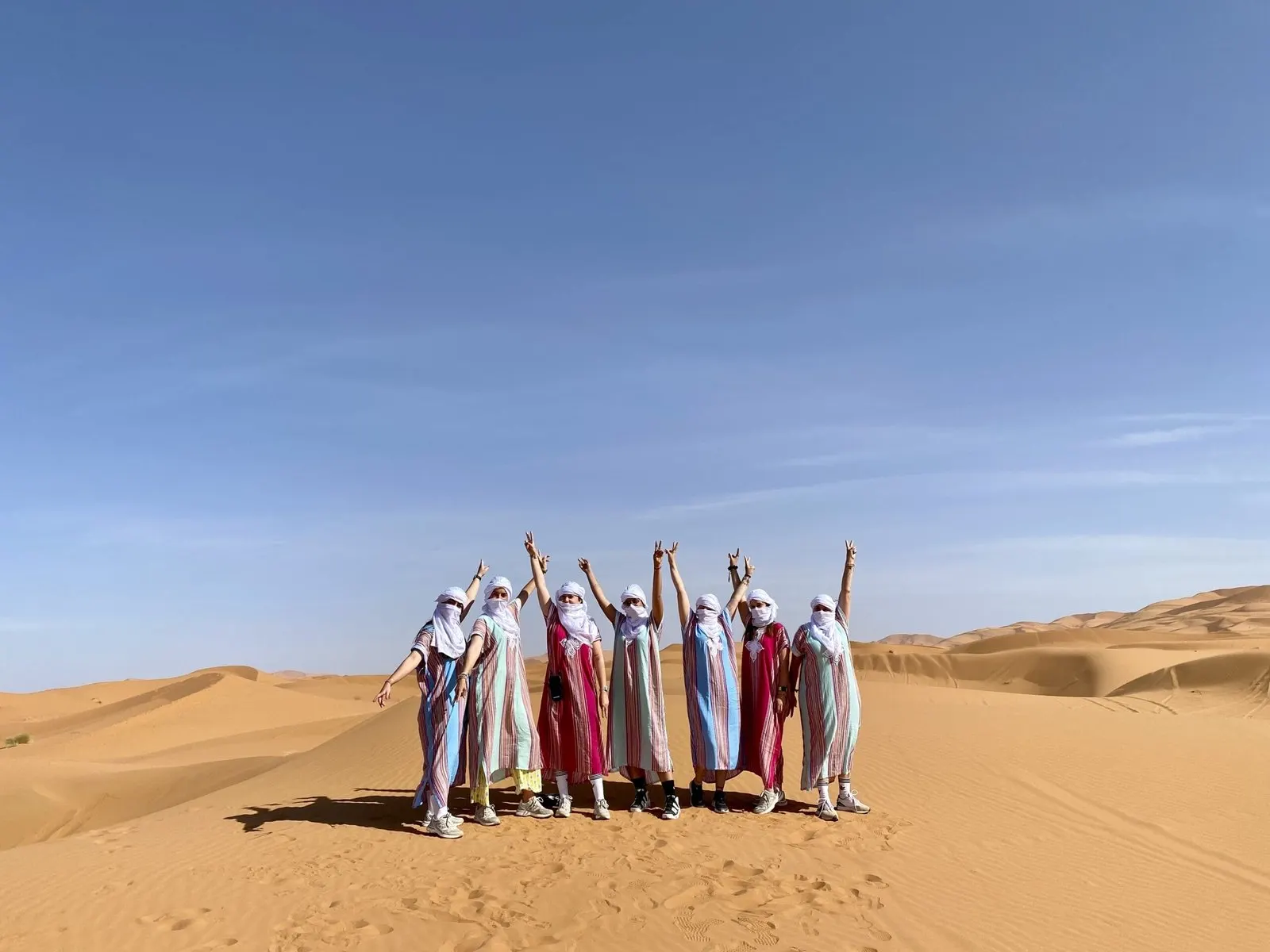 A group of travellers standing on a dune